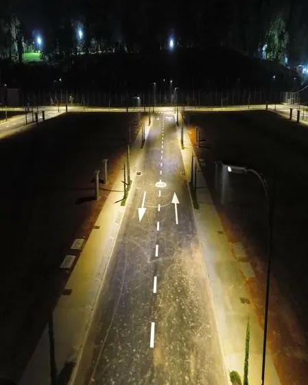 Vía iluminada de noche con luminarias solares